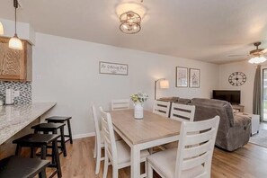 Dining are with seating for six at table and four at bar