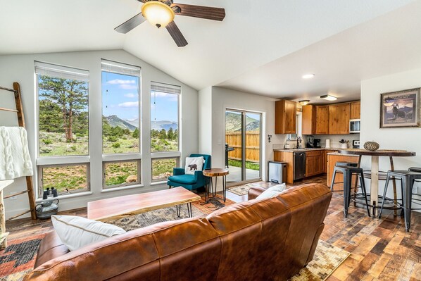 Open concept living area, serene views, open to dining area and kitchen. NOTE: table has been updated.