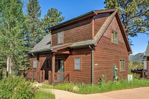 Solitude Bobcat 2 - Exterior of cabin, with small porch that wraps around to deck, and front door.