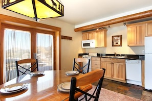 Entrance into the kitchen/dining area with seating for 4. Kitchen has stove,microwave, refrigerator and dishwasher.