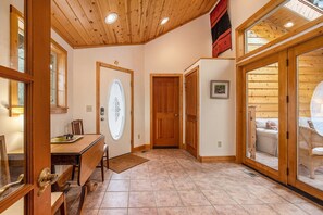 Kittery West Estes Park, Entryway front door, table with 2 chairs, doors to screened patio.