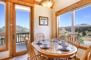 Comanche Peak 39 - Dining table with seating for six surrounded by windows and beautiful mountain views.