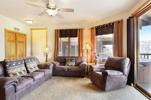 Comfortable seating in living area with a queen sleeper sofa, loveseat and oversized chair.