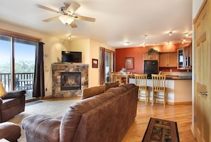 Spacious living area with warm fireplace and a queen sized pull out sofa, flat screen TV