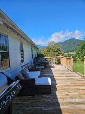 Deck with outdoor seating and grill.
