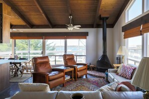 Living room w/ fireplace & ocean views