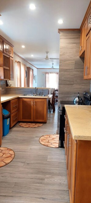 Kitchen equipped with refrigerator, stove, and microwave 