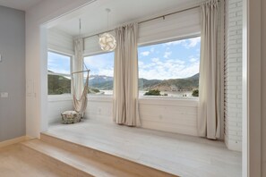 Cozy loft nook with hammock chair and stunning views.