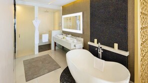 Luxury bathroom with freestanding tub, walk-in shower, and double vanity.