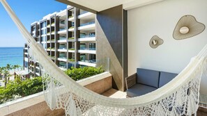 Private balcony with hammock, seating, and ocean views at Garza Blanca Cabo.