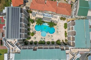 Experience the epitome of tropical luxury with a bird's-eye view of Palm Aruba Condos. Captured from above, the sprawling pool and lush grounds beckon with promises of relaxation and recreation