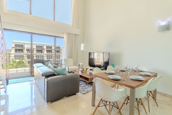 Step into comfort and elegance as you enter the spacious living room and dining area of Palm Aruba. Designed with modern sophistication and island charm, this inviting space beckons you to relax and unwind.