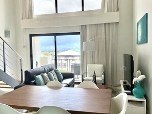 Whether you're enjoying a leisurely meal with loved ones or lounging in the cozy seating area, the living room and dining area of Palm Aruba sets the stage for unforgettable moments in paradise.