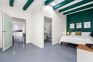 Chic and cozy bedroom  with a stylish emerald accent wall – perfect for a relaxing stay in the city. Featuring a comfortable bed, modern amenities, and a connected private bathroom for your convenience.