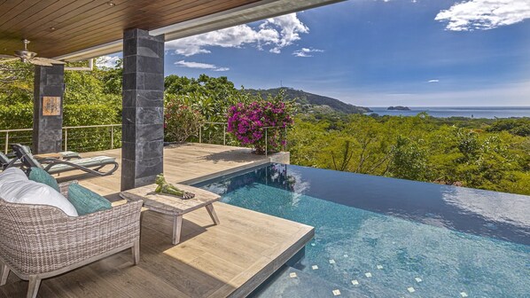 Enjoy sweeping views of the Pacific Ocean and surrounding tropical hillsides.