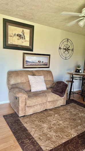 Step into the living, dining,kitchen area. Comfy recliner couch!