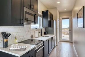 Full Kitchen including a full-size fridge, freezer, oven, dishwasher, microwave, toaster, and more