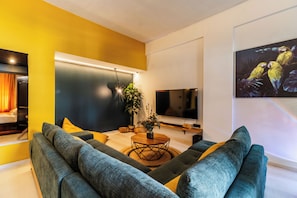 Stylish living room with bold yellow tones, a green sectional sofa