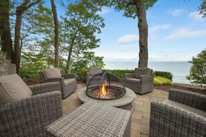 Cozy up by the fire, steps from the shore.