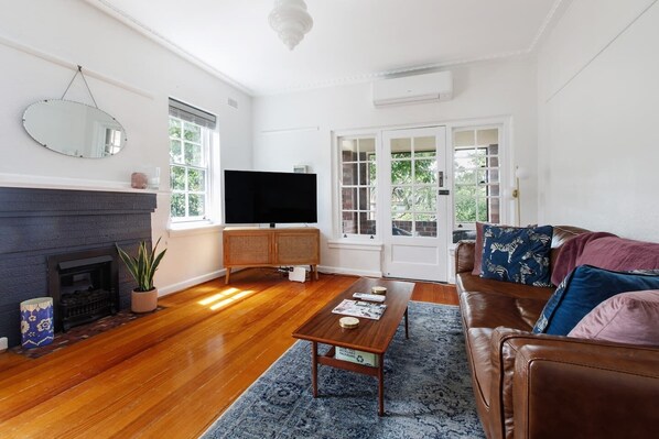 The open-plan living room has a comfortable leather lounge to stretch out along and watch your favourite television show. 
