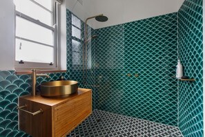 The bathroom has a spacious shower with a rain shower and massage head for a soothing rinse. 
