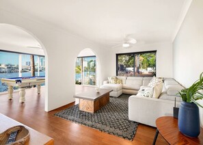 The spacious, open-plan living area includes a generous sofa where you can settle in with some Netflix or simply kick back and enjoy the breathtaking river views.
