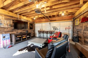 Our gaming garage is fully equipped with a smart TV, comfy seating, and games.