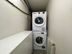 Laundry Convenience: A dedicated laundry area equipped with a washer and dryer, ensuring a hassle-free stay with all the essentials for fresh clothing.