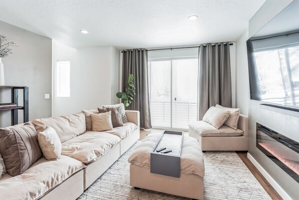 Living room with cozy fireplace and LARGE TV.