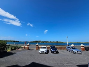 Car park with view of marine lake to front of the property