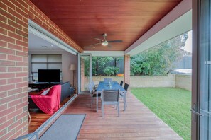 Enjoy alfresco dining at home in the beautiful garden. There is a lush green yard, swimming pool and large outdoor dining table, perfect for entertaining.
