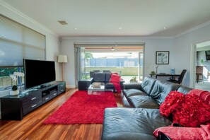 The central living room flows seamlessly to the alfresco dining area, creating a lovely flow with the outdoors.