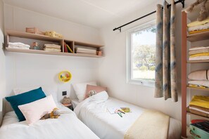 Bright and airy, this bedroom is designed for comfort, with soft touches and plenty of natural light for a restful retreat.