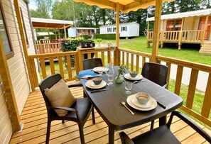 Dine alfresco on this charming covered patio, where every meal feels like a special occasion under the open sky.