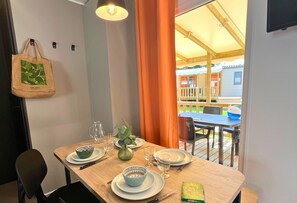 A welcoming dining nook awaits, styled with warm accents and set for an enjoyable meal indoors or out on the deck.