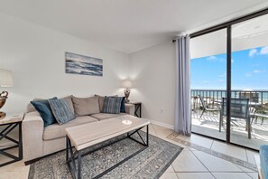 The cozy living area is accented by a comfortable, plush sofa perfect for settling in to watch your favorite show on the cable-enabled Smart TV.