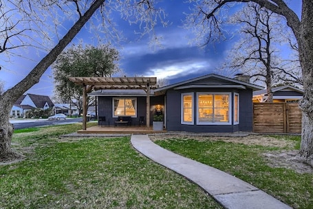 Charming exterior with a welcoming front porch and beautifully landscaped yard.