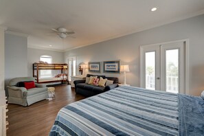 In addition to the bed, couch, and chair there are also bunk beds.