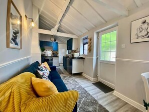 Open plan sitting, tv, dining, kitchen area.
