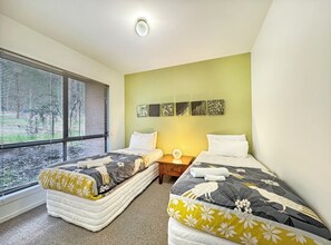 Bedroom 3, situated downstairs, offers two single beds for comfortable accommodation.