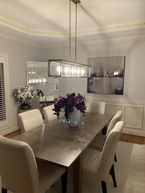 Tastefully decorated dining room with seating for 8 and wine fridge