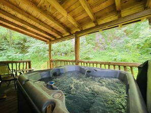 Private hot tub on back porch of the cabin