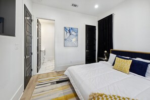 Bedroom 1- King bed, overhead fan, wall mounted smart HDTV, en suite bath
