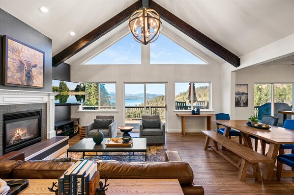 Floor-to-ceiling windows showcase the stunning views of the lake and surrounding mountains