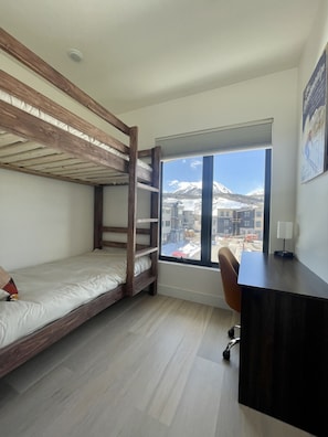 Wood Bunk Bed, Work Space with High-Speed Internet, and Privacy with pocket door
