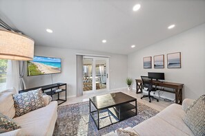 The inviting living room and office space, with sliding doors that lead out to the porch!
