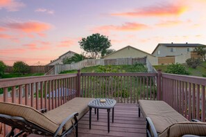 Private balcony off the primary bedroom features sun loungers.