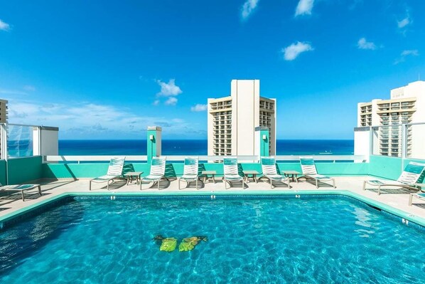 Swimming pool with poolside loungers