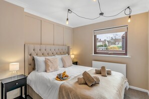 Indulge in regal comfort: Bedroom 3 beckons with a lavish king-size bed, ensuring nights of unparalleled relaxation in our welcoming property. 