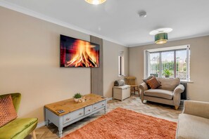 Relaxation redefined: Sink into comfort in our stylish living area, featuring a TV for your entertainment. The ideal haven to unwind and recharge in style.